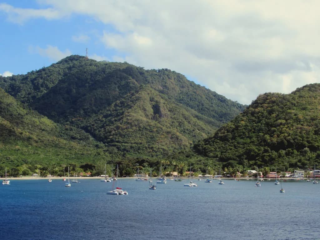 Baie de Grande Anse d'Arlet fermée par les mornes, avec des voiliers au mouillage
