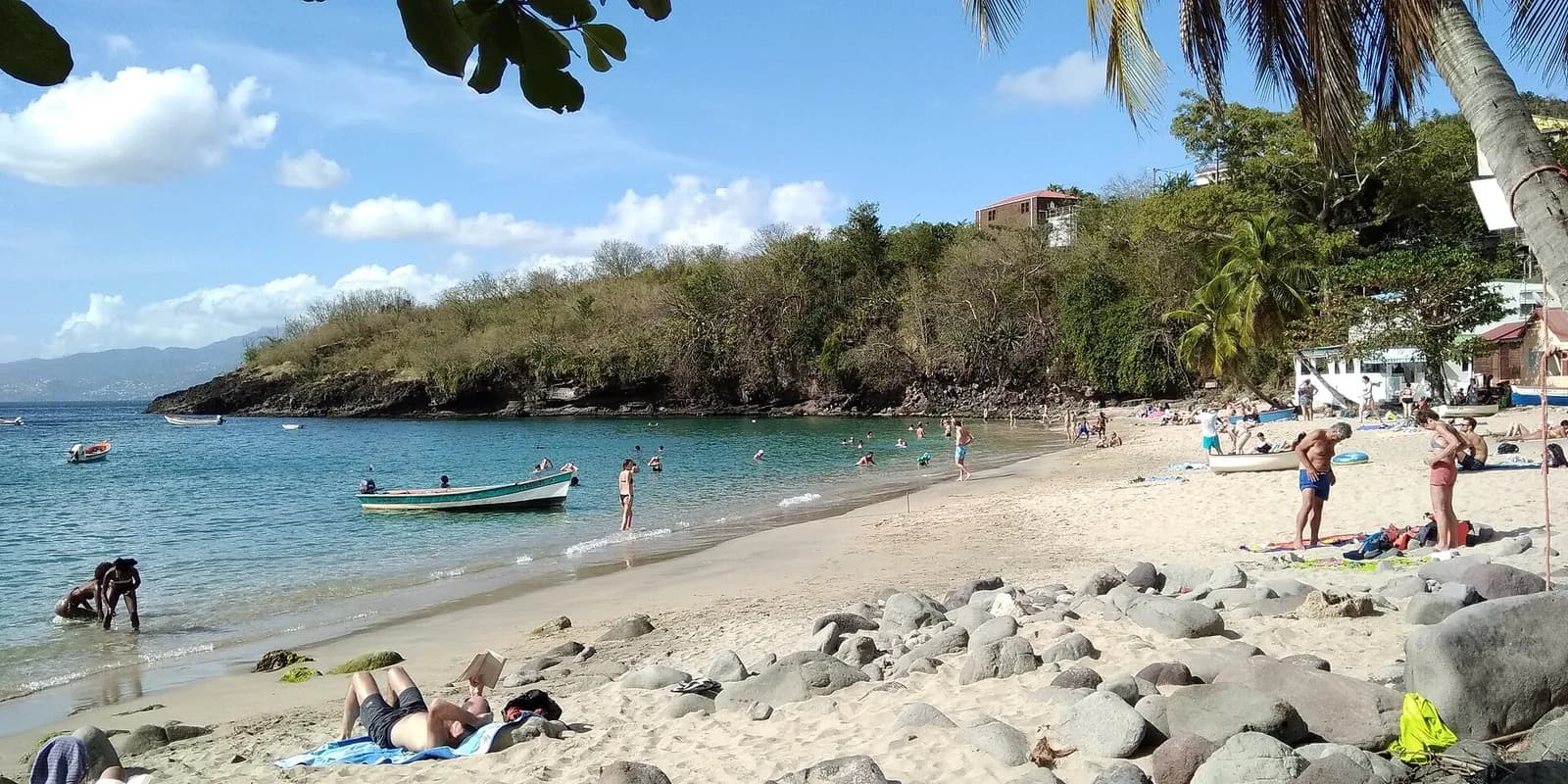 La plage de l'Anse Dufour aux Anses-d'Arlet, avec baigneurs et barque de pêche