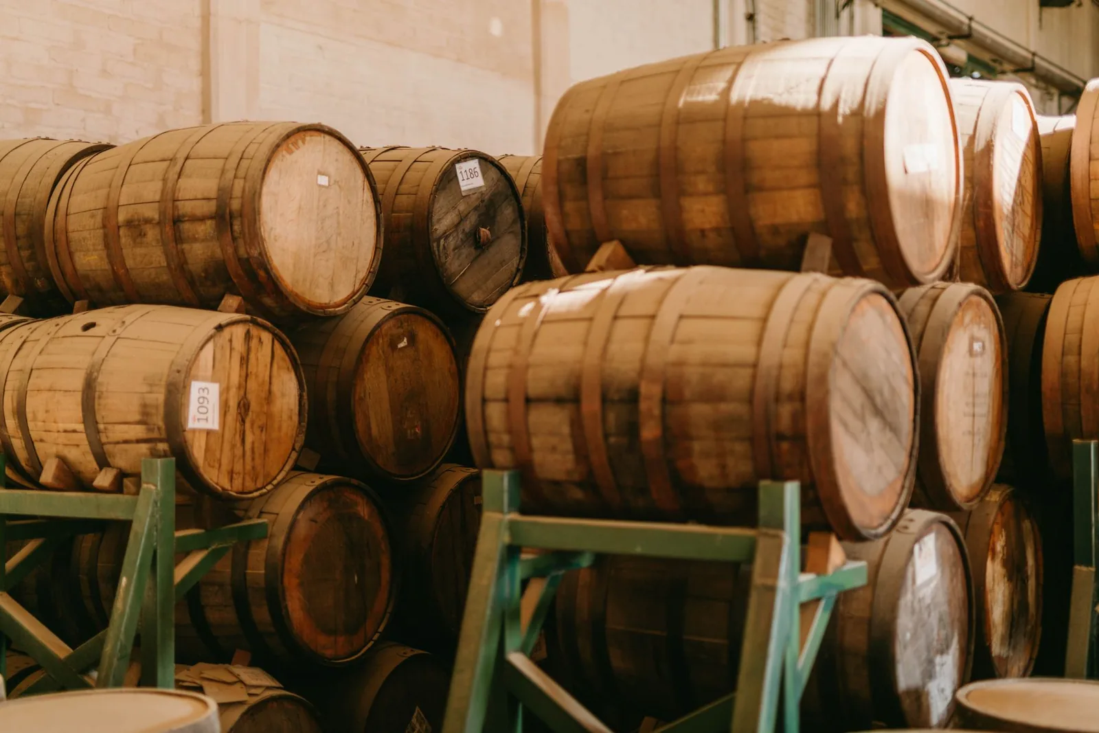 Fûts de chêne empilés dans un chai de vieillissement de rhum